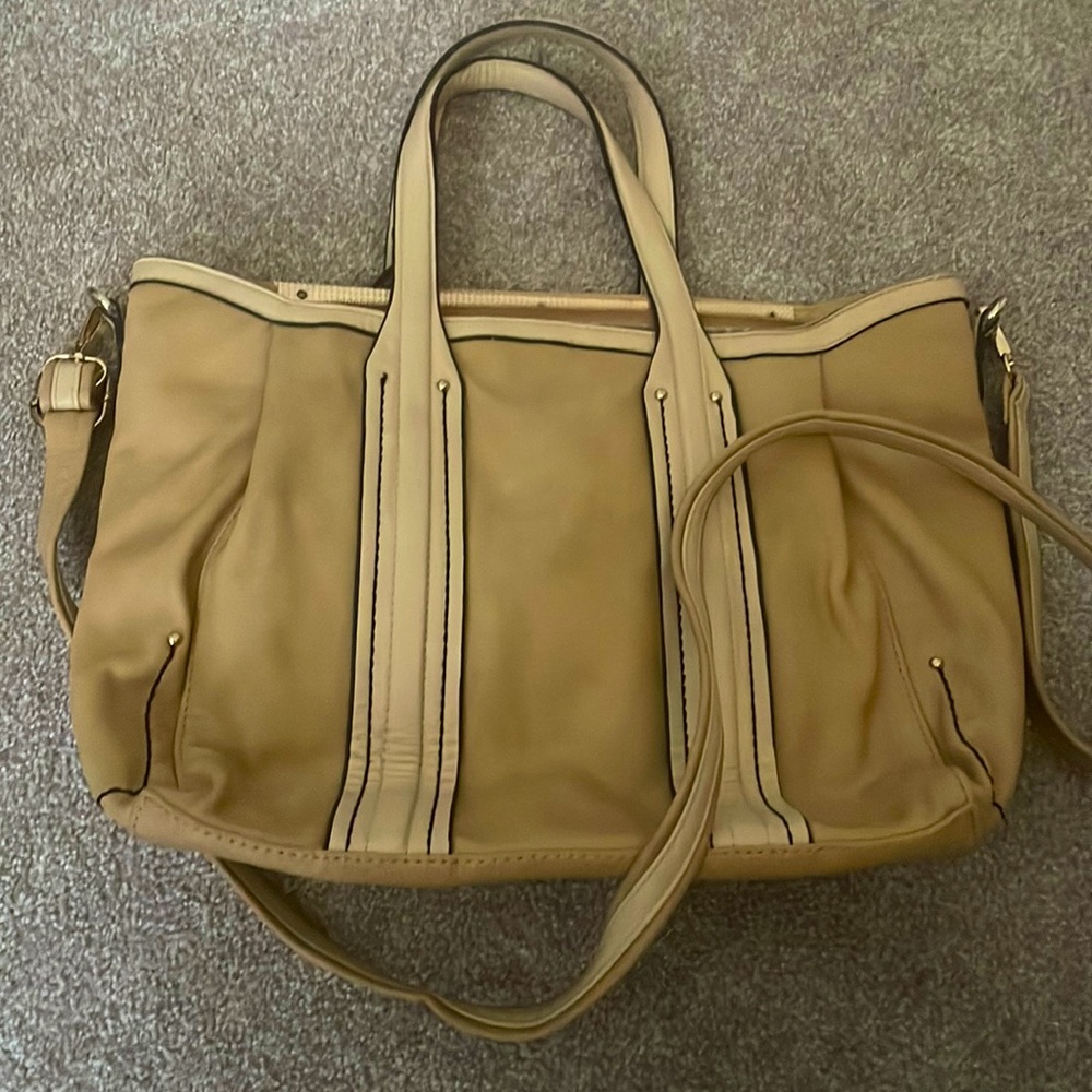 Light beige to cream color bag/purse with strap.